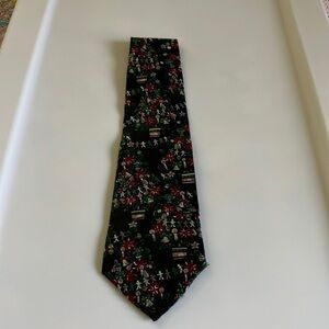 Damani men’s Christmas tie. The color is black decorated with poinsettias.